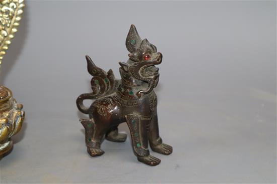 A Sino Tibetan bronze figure of Buddha Shakyamuni and a Thai lion dog